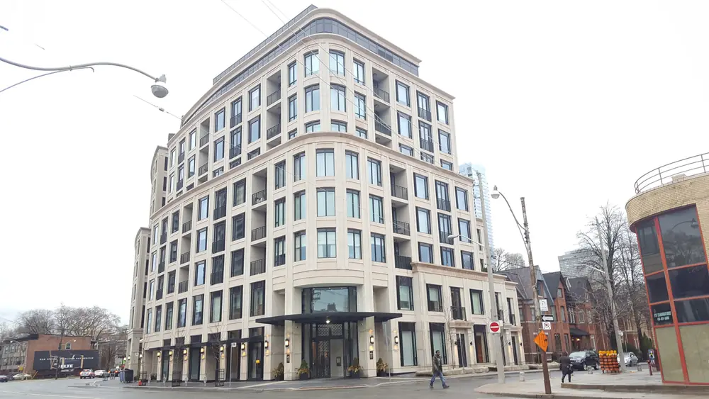 A stone-clad mid-rise residential building at 133 Hazelton Avenue, Yorkville, Toronto