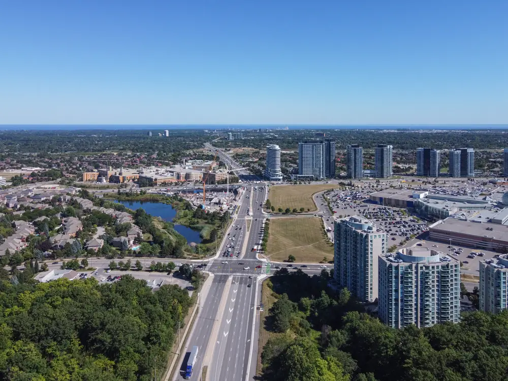 Aerial view along Erin Mills Parkway past Erin Mills Town Centre and condo towers, Mississauga