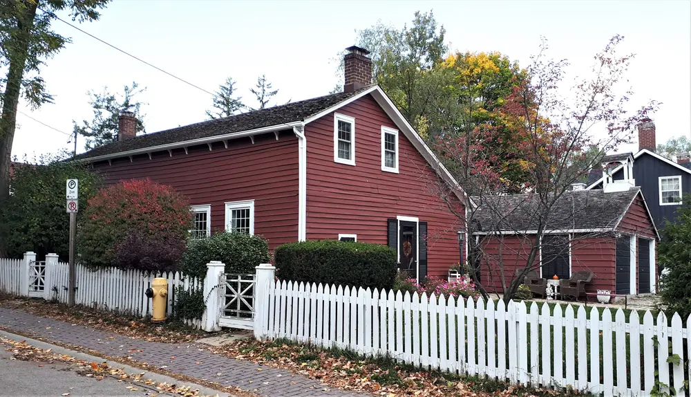 The William Lane Cooper House, a red clapboard cottage behind a white picket fence in Thornhill, Markham