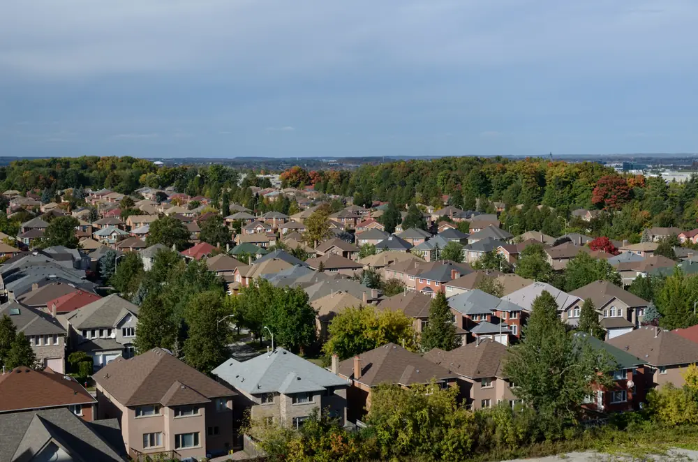 Rooftops of detached houses among trees in a Richmond Hill neighbourhood in autumn