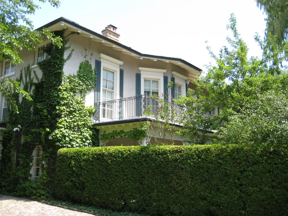 Drumsnab House, a white stuccoed house behind a tall hedge on Drumsnab Road, Rosedale, Toronto