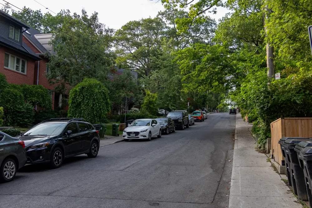 Tree-lined residential street with parked cars off Victoria Park Avenue in Birch Cliff, Scarborough, Toronto
