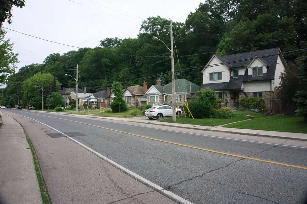 Detached houses with lawns under tall trees along South Kingsway, The Kingsway, Toronto