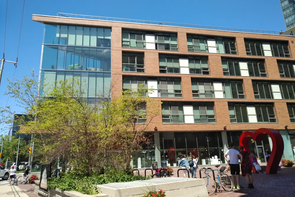 A modern brick-and-glass condo building on Gristmill Lane in the Distillery District, Toronto