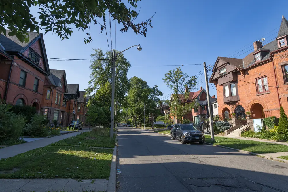 Looking north along tree-lined Madison Avenue in The Annex, Toronto, with large brick Victorian houses