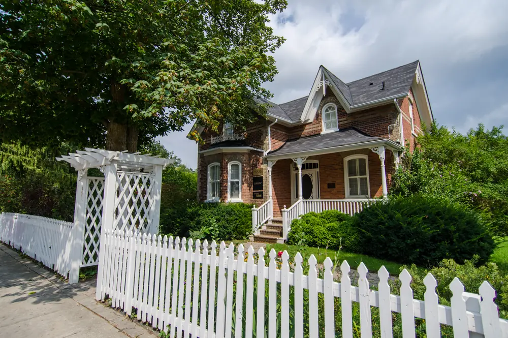 The Thomas White House, a red-brick Gothic Revival home behind a white picket fence on Islington Avenue, Kleinburg, Vaughan