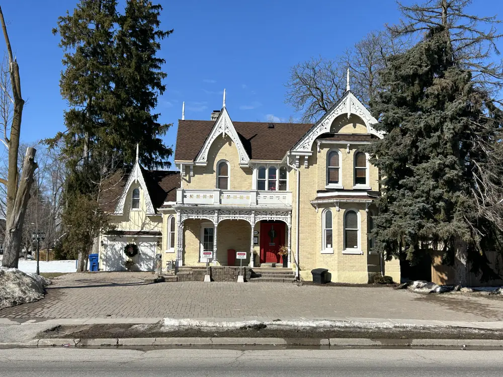 A cream Victorian house with gingerbread trim at 6060 Main Street, Stouffville