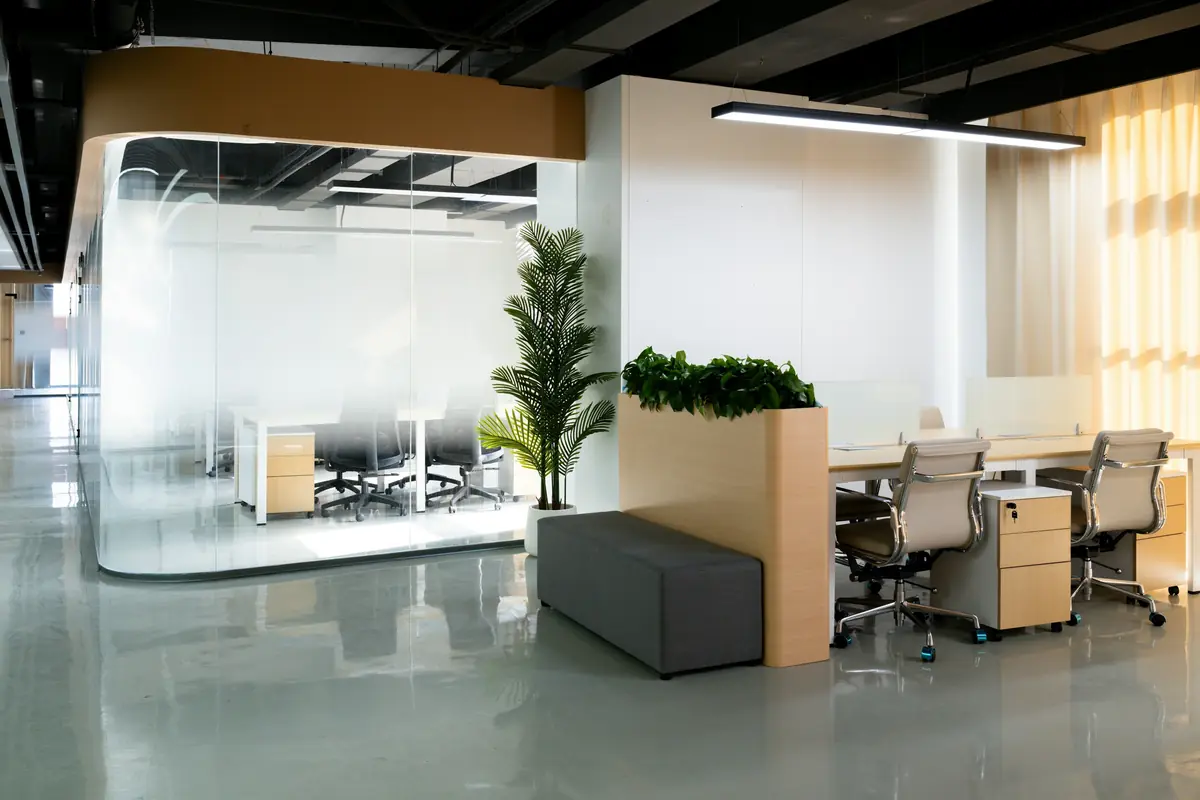 A bright, clean modern office with a glass meeting room