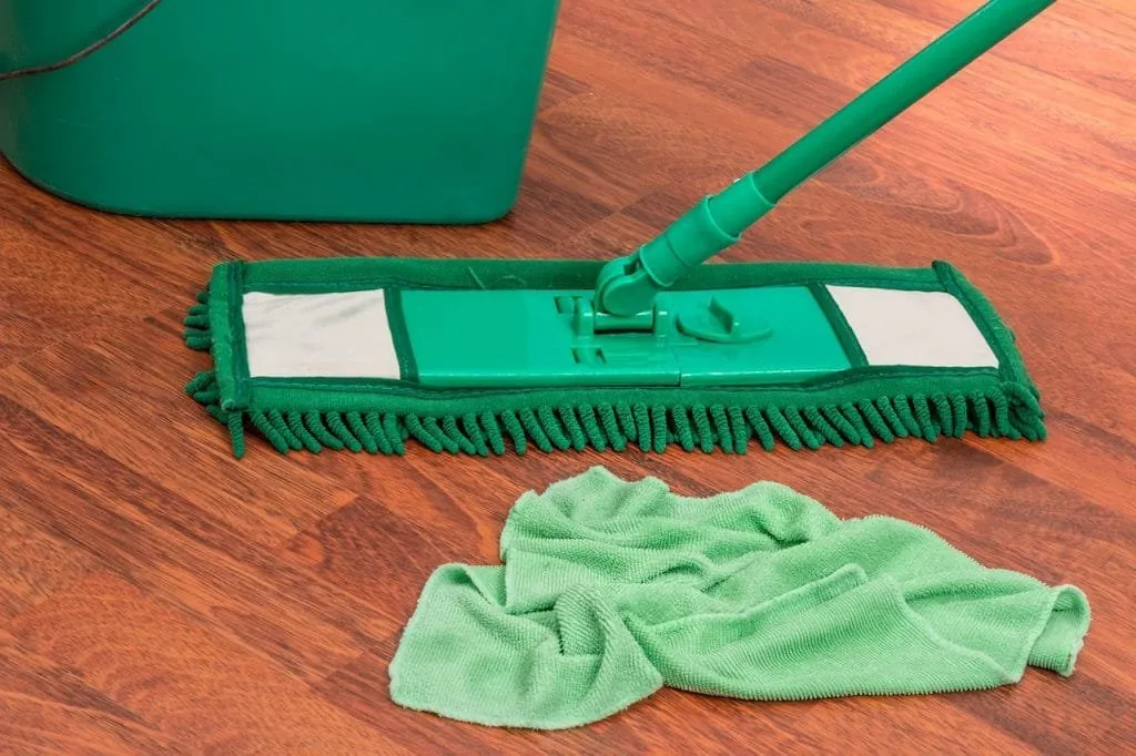 A microfibre mop and cloth on a gleaming hardwood floor