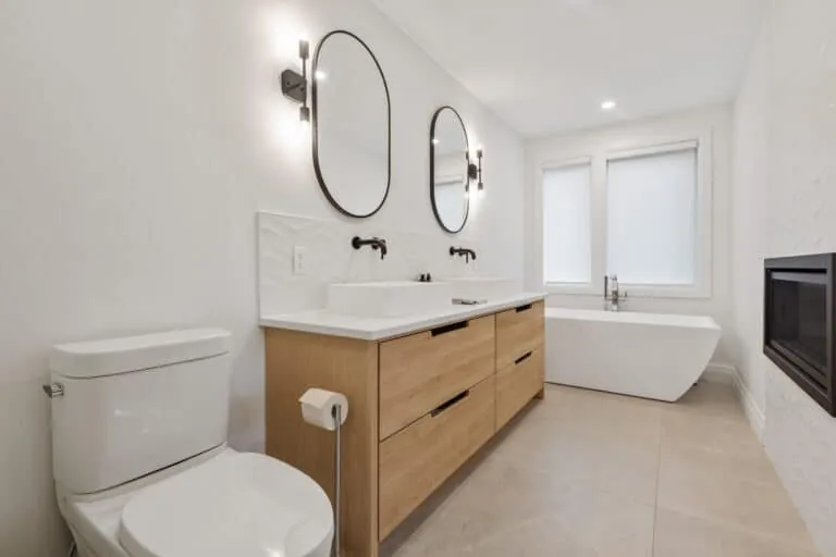 A clean modern bathroom with a double vanity and freestanding tub