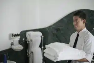 Professional maid carrying towels