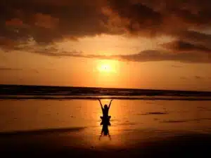 Person stretching at sunset outdoors