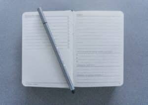 Open notebook with pen for daily journaling or note-taking. Cleaning Schedule