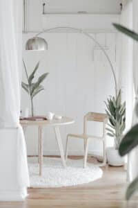 Healthier environment with plants, white tables, chairs and carpet