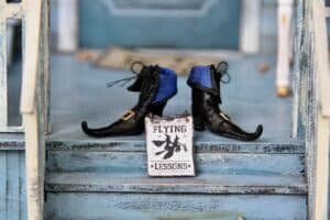 Pair of witch-themed Halloween-themed boots at home entryway
