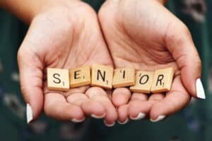 Woman holding senior scrabble pieces