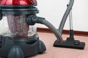 Professional vacuuming in home office setup.