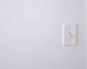 White wall with white electric switch, High-Contact Surface Cleaning