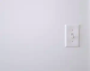 White wall with white electric switch, High-Contact Surface Cleaning
