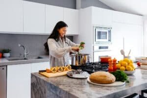Woman preparing a meal in a clean kitchen with clean appliances