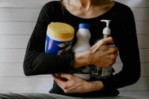 Woman with cleaning materials and agents, Post-Halloween Home Cleanup